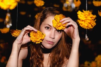 Woman Poses With Orange Blossoms