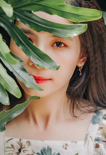 Woman Posing Behind Plant
