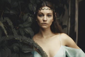 Woman Posing By A Plant