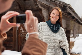 Woman posing for photograph outside cabin