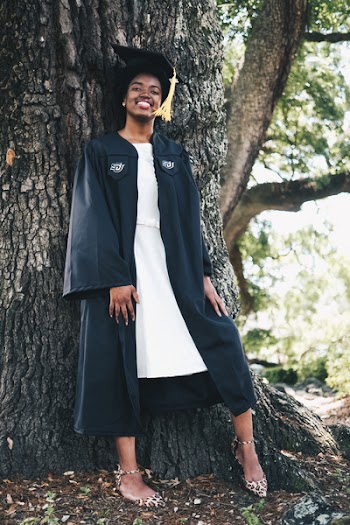 Woman Posing in Front of Tree