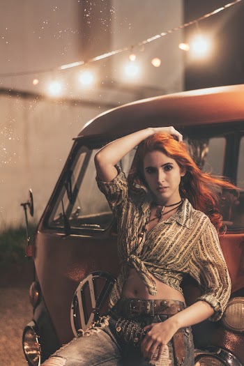 Woman Posing Infront Of A Vehicle