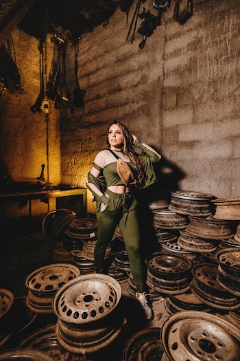 Woman Posing Inside A Room Of Vehicle Rims