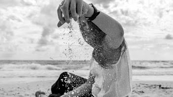 Woman Pouring Sand Grayscale Photography