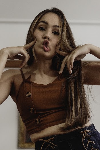 Woman Pouting Her Lips and Touching Her Cheeks