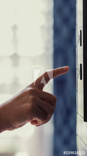 Woman pressing an elevator button