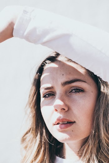 Woman Puts Her Left Arm Above Her Head