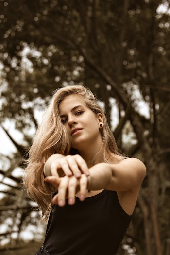 Woman Raising Both Hands Pointing in Front