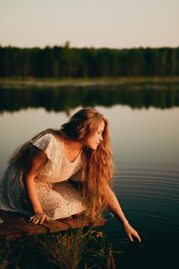 Woman Reaching Out to Touch Surface of Water · Free Stock Photo