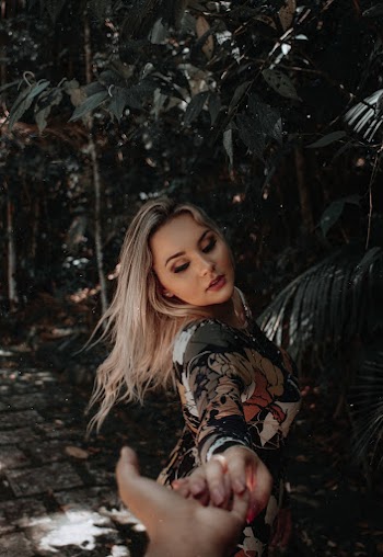 Woman Reaching Person's Hand at the Garden