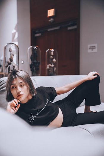 woman reclining on gray sectional sofa