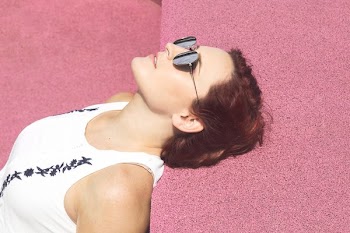 Woman Relaxes On Pink