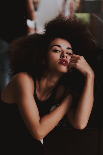 Woman Resting Arm on Piano