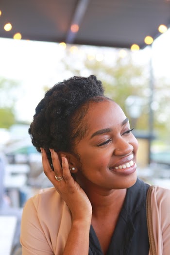 Woman Resting Hand on Ear