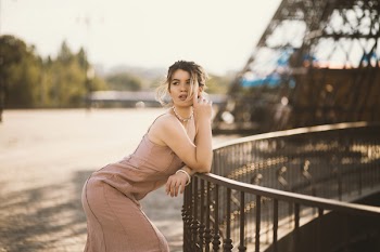 Woman Resting Her Arms On Railing