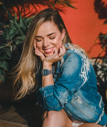 Woman Resting Her Chin on Her Hands While Smiling