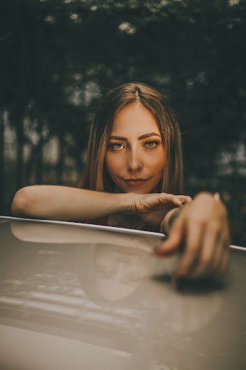 Woman Resting Her Hand on Brown Surface
