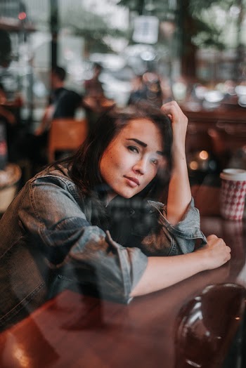 Woman Resting Her Head on Arms