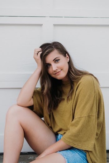 woman resting her head on her right hand