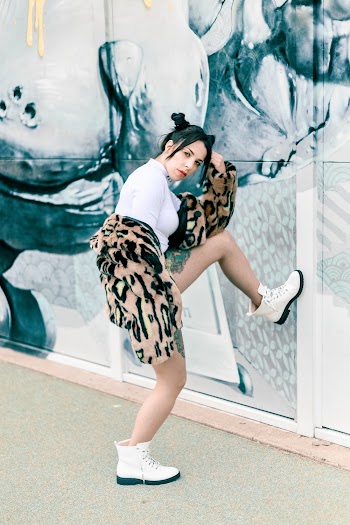 Woman Resting Her Left Foot On Wall
