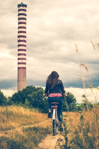 Woman Riding Bicycle Near Lighthouse