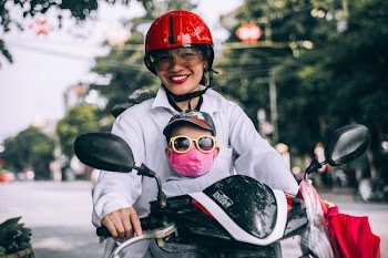 woman riding black motorcycle