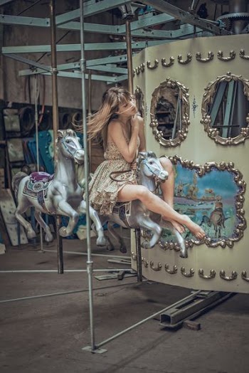 woman riding carousel