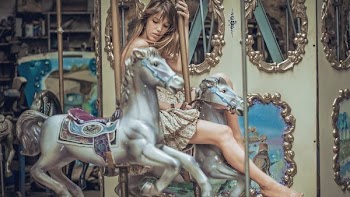 woman riding horse carousel