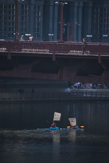 woman riding on blue kayak on body of water