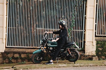 Woman Riding on Green Motorcycle