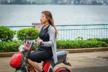 Woman Riding Red Motor Scooter