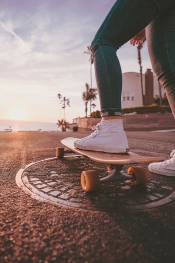 woman riding skateboard during daytime