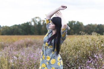 Woman Rising Her Arms Surrounded by Flower