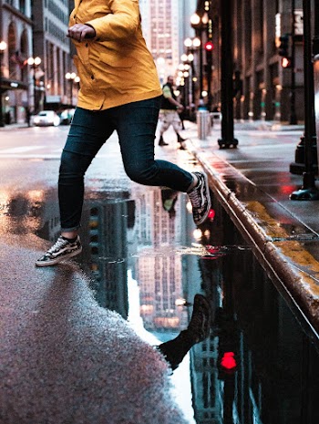 Woman Running On Wet Road