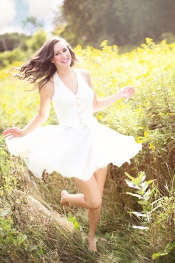 Woman Running Surrounded by Grass