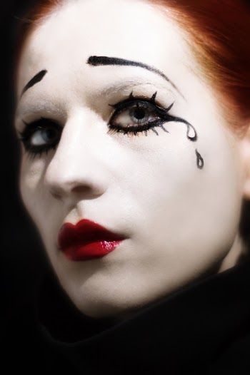 woman's face painted as sad mime