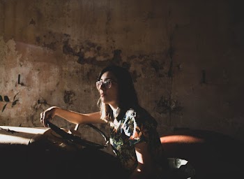 Woman Seated in Vintage Car