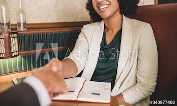 Woman shaking hands with business partner