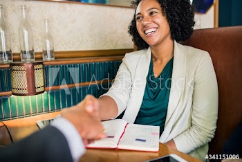 Woman shaking hands with business partner
