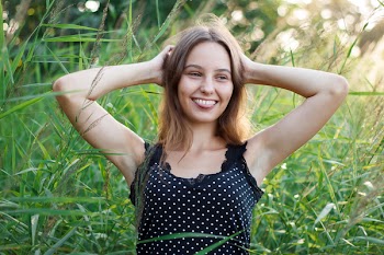 Woman Showing Her Tongue While Holding Her Head