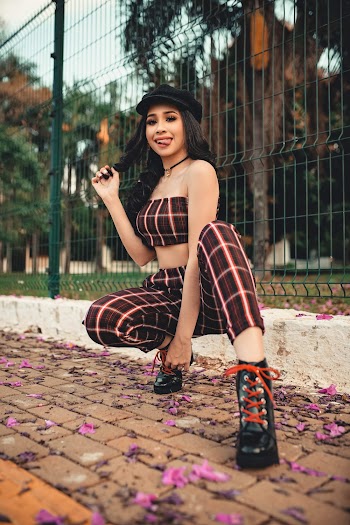 Woman Showing Out Her Tongue Sitting Near Fence