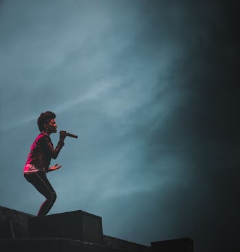 woman singing on stage