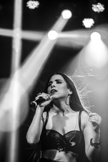 Woman Singing While Holding Microphone