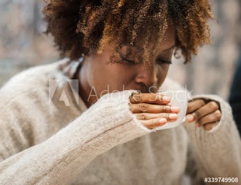 Woman sipping on a hot coffee