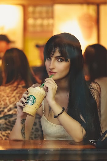 Woman Sipping Starbucks Coffee