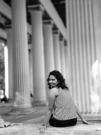 Woman Siting on Concrete Pavement Grayscale Photography