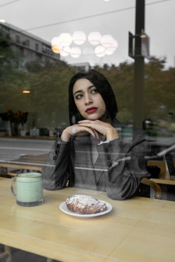 Woman Sits in Coffee Shop