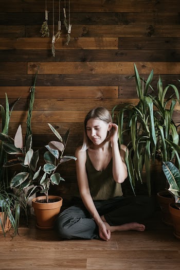 Woman Sits Near Wall