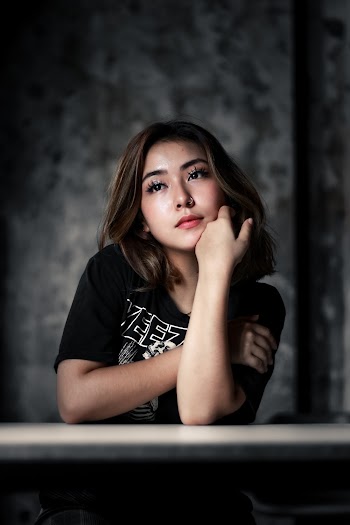 Woman Sits Near Wall