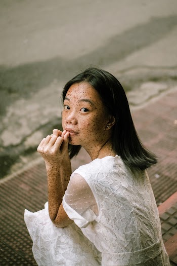Woman Sits on Pavement